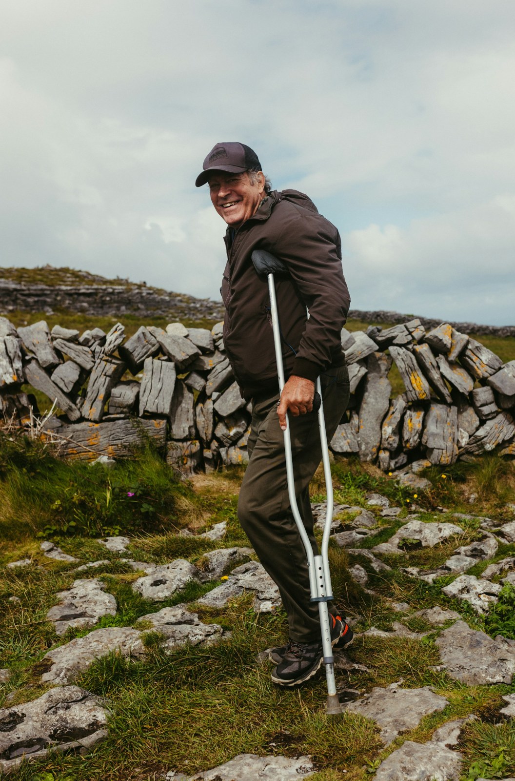 Man walking with crutches while recovering from an injury